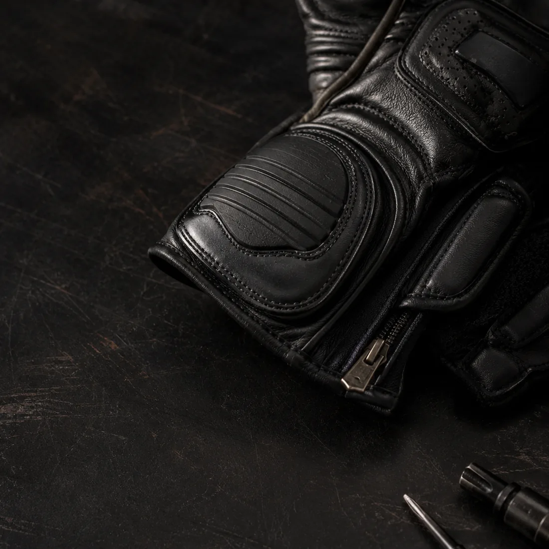 Anonymous black protective leather riding gear detail